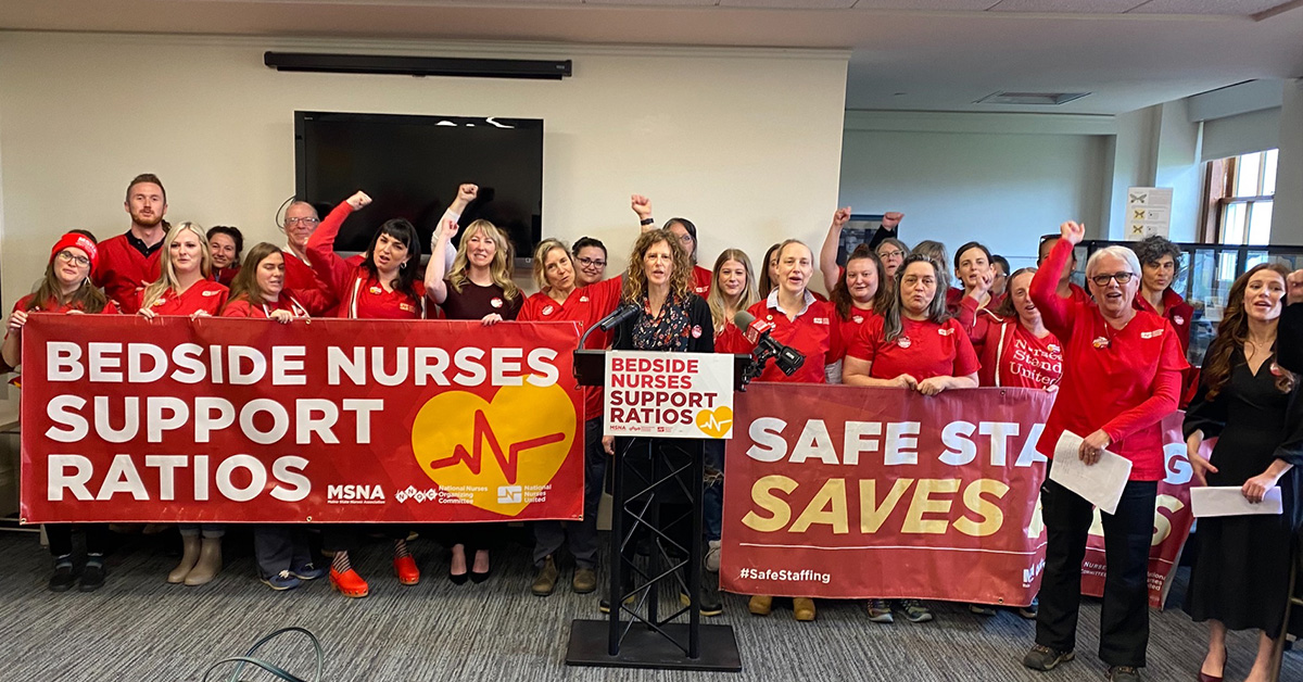 Maine nurses taking action for safe staffing, holding banner that reads "Bedside nurses support ratios!"