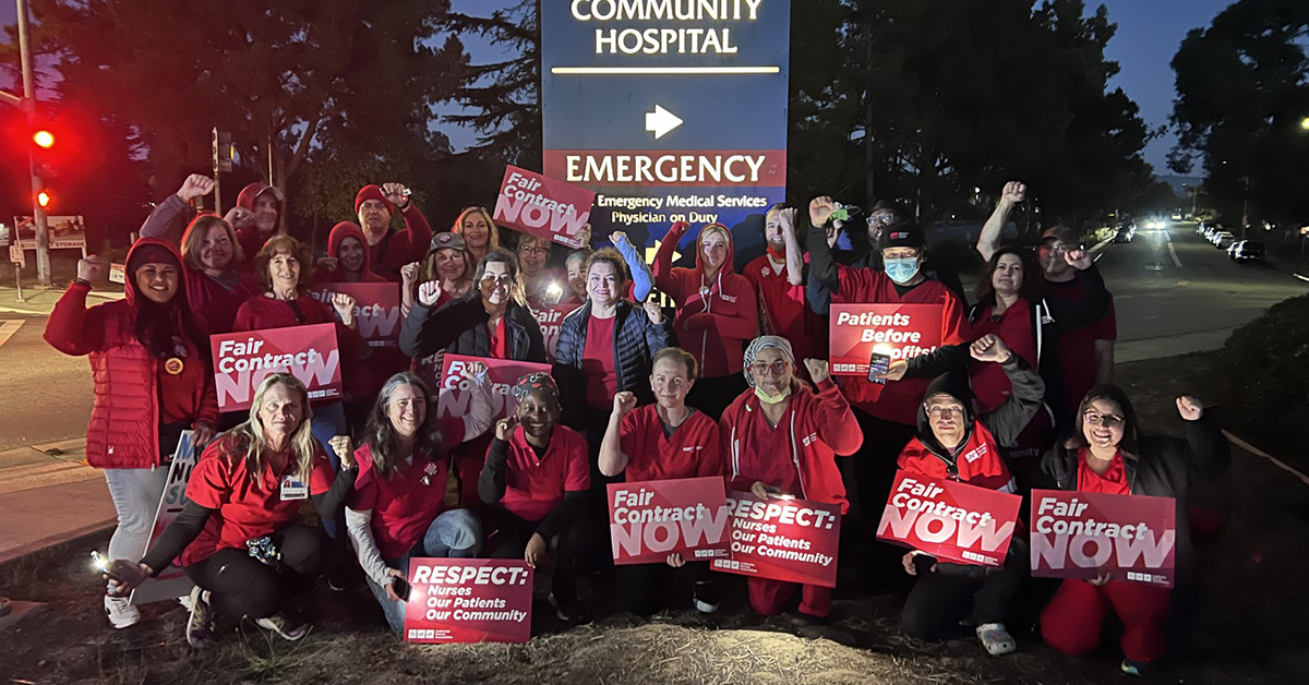 Large groups of nurses outside Watsonville Community Hospital holding signs "Fair Contract Now"