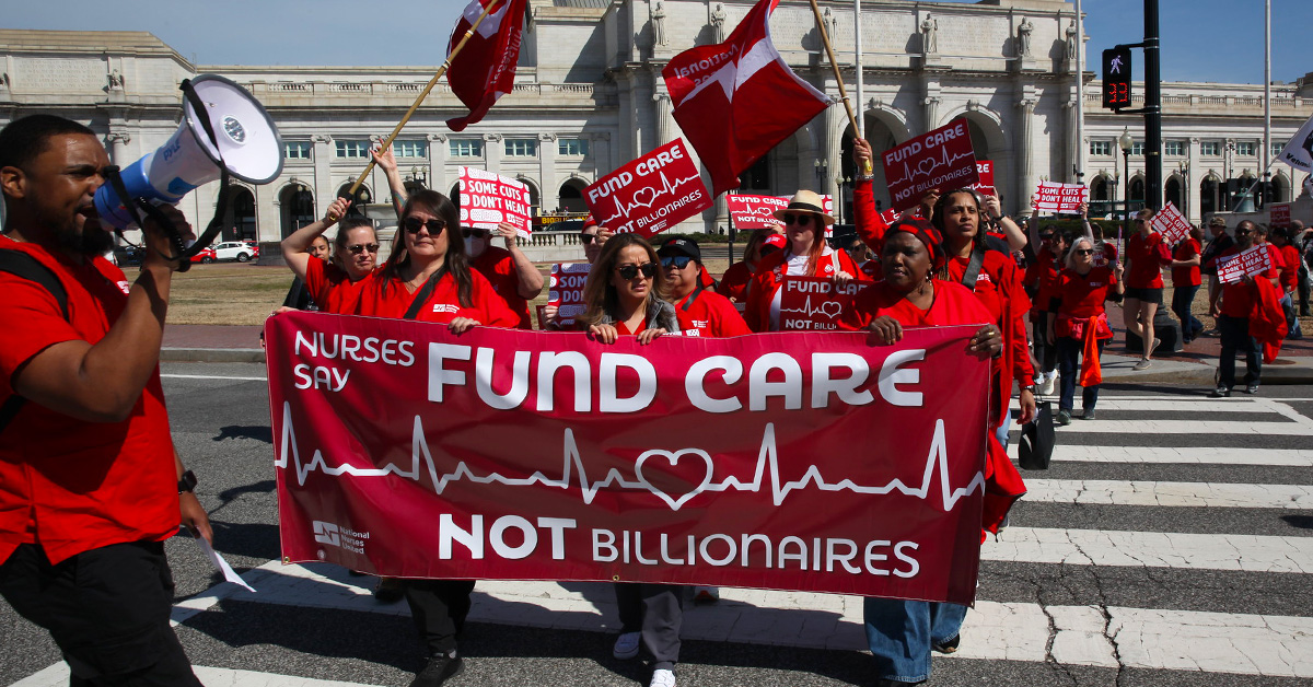 Nurses marching with banner "Fund Care NOT Billionaires"