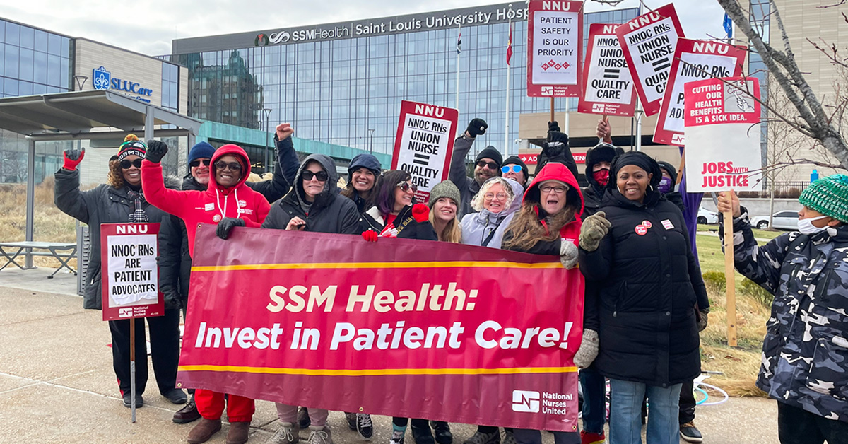 Group of nurses outside hospital, smiling, raised fists, holding banner "SSM Health: Invest in Patient Care"
