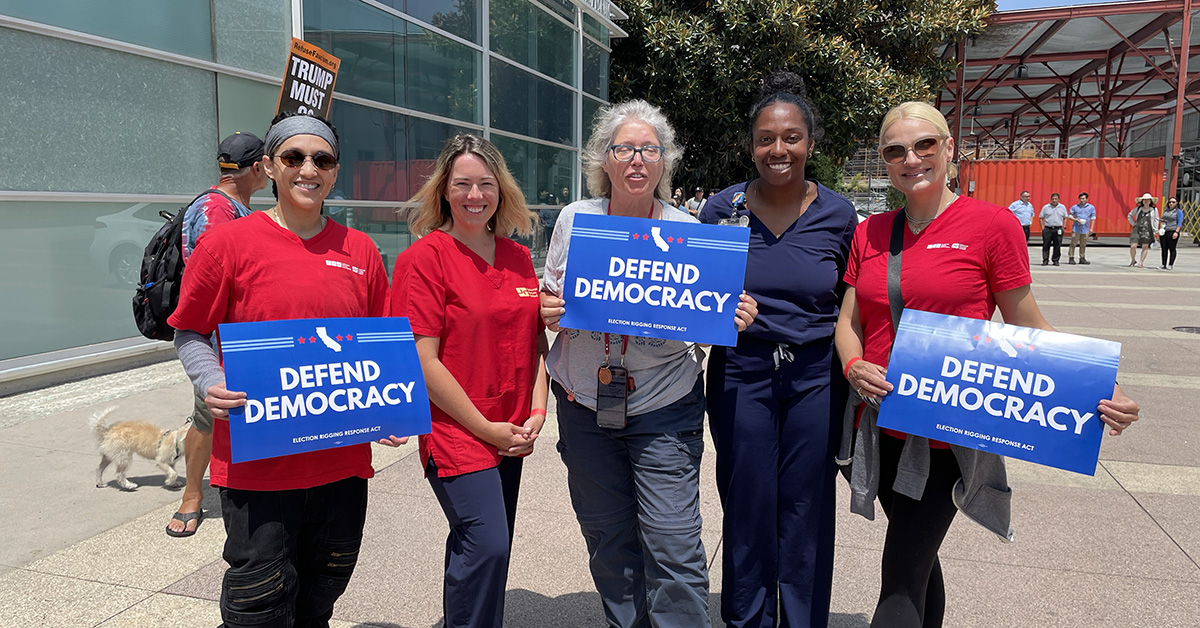 California nurses hold signs that read "Protect Democracy."