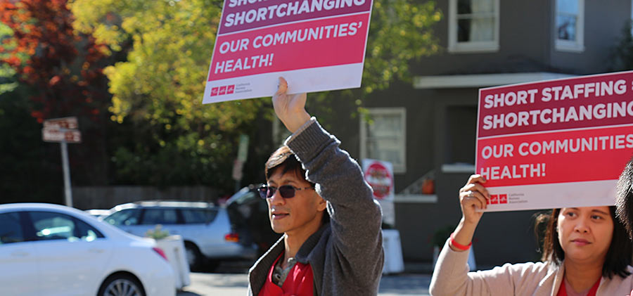 Health care workers with signs