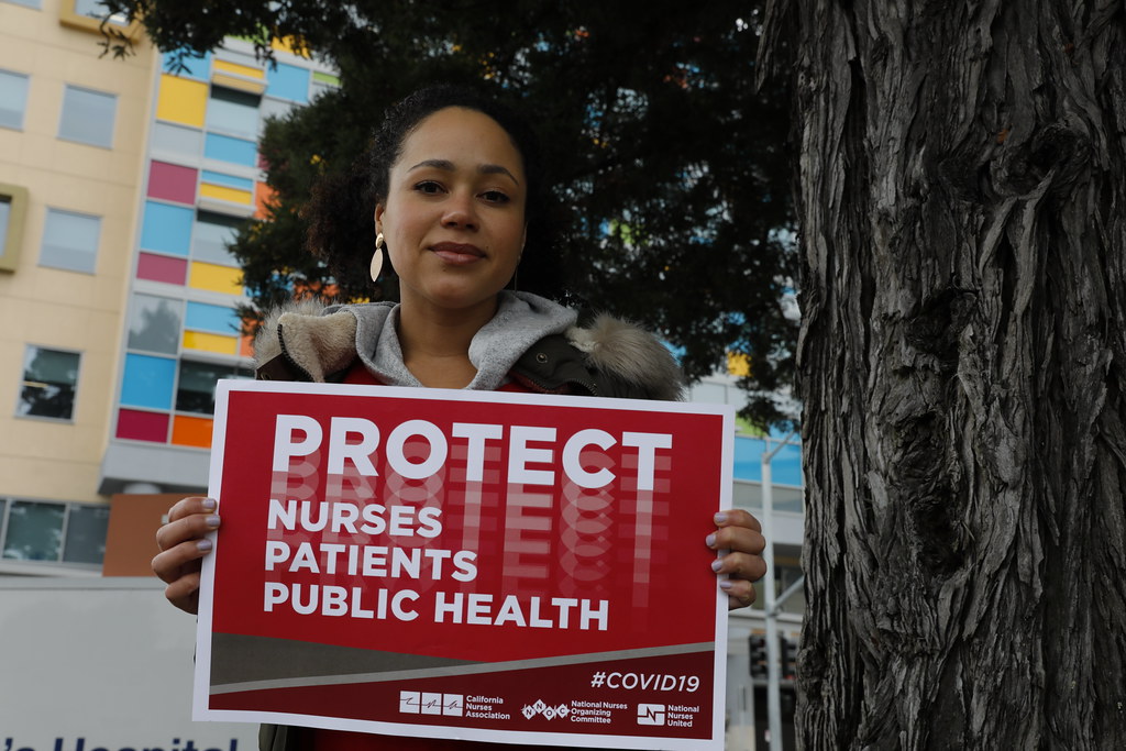 Nurse holding sign for more PPE