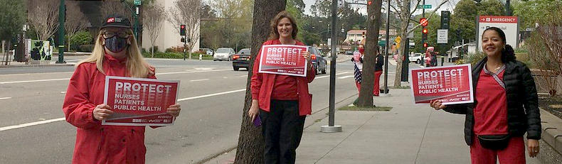 nurses holding signs