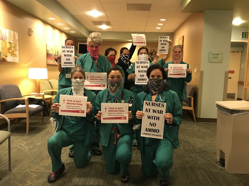 nurses holding signs