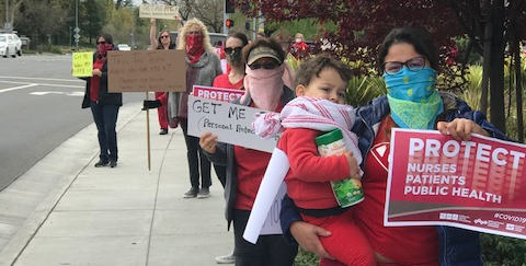 nurses holding signs