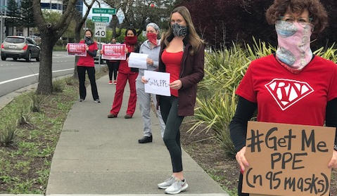 nurses holding signs