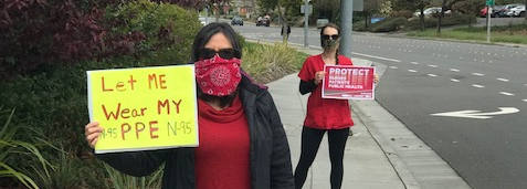 nurses holding signs