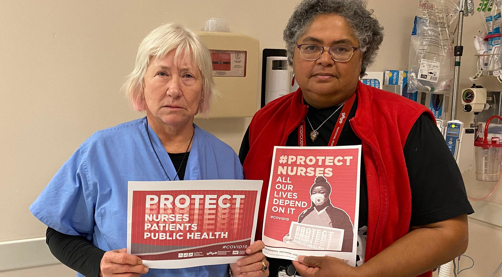 nurses holding signs