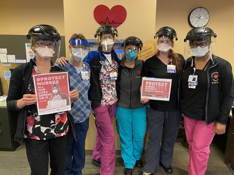 nurses holding signs