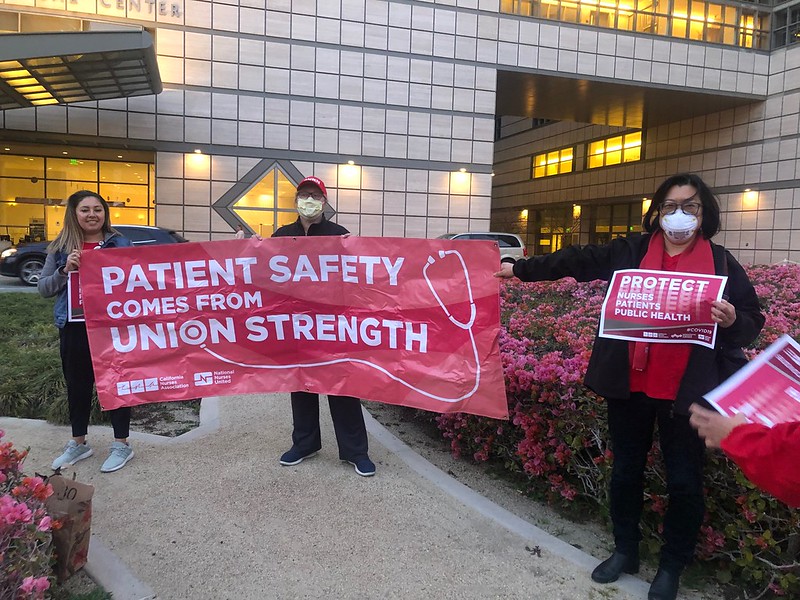 nurses holding signs