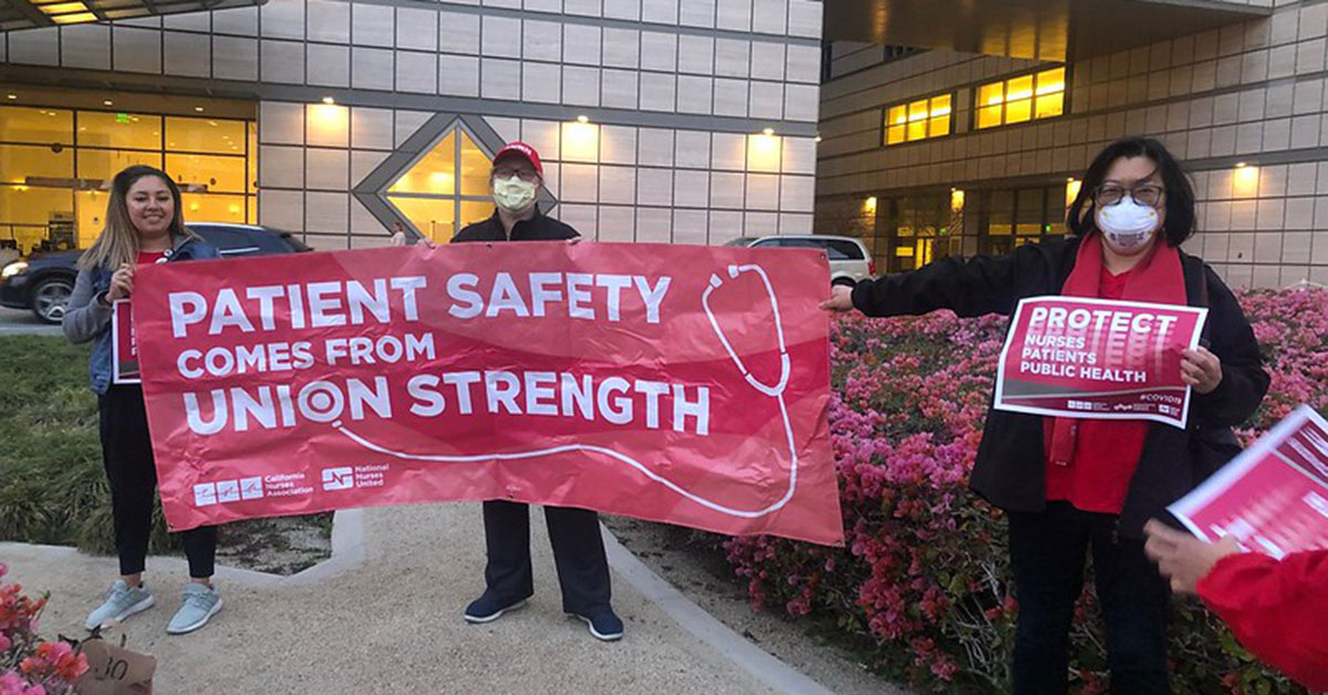 UCSD La Jolla nurses holding banner that reads "Patient safety comes from union strength!"