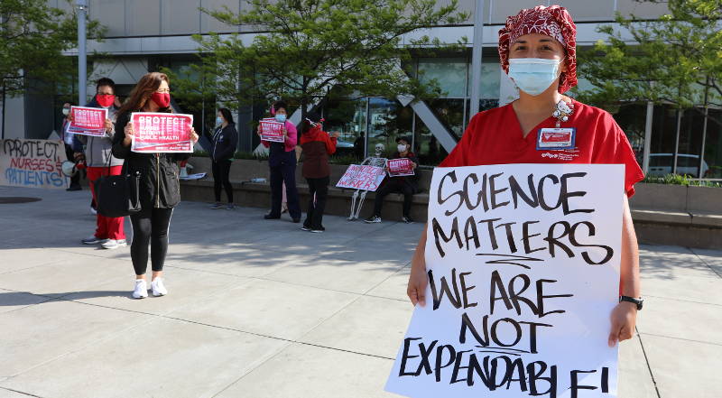 nurses holding signs