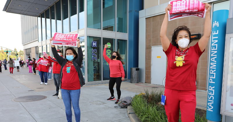 Nurses outside facility holding action