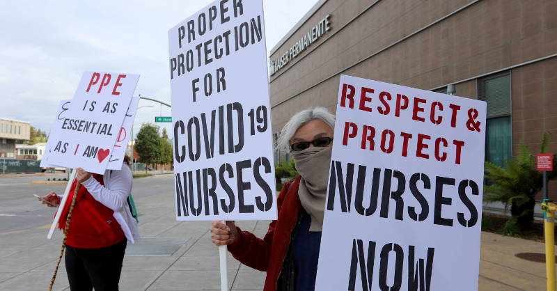 nurses holding signs