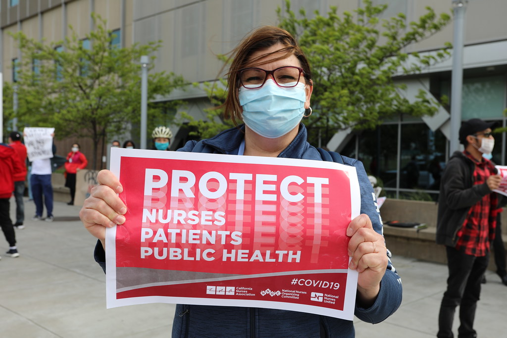 nurses holding signs