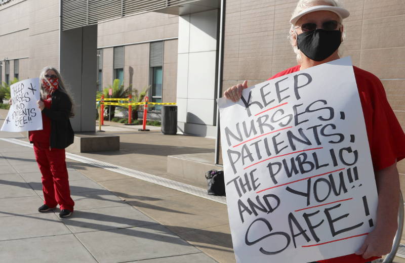 nurses holding signs