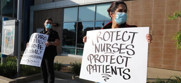 nurses holding signs