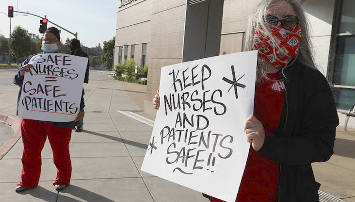 nurses holding signs