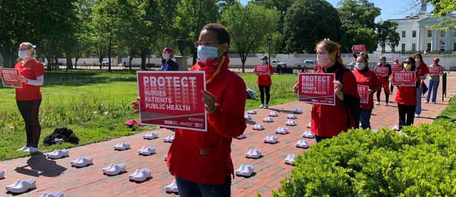 nurses holding signs