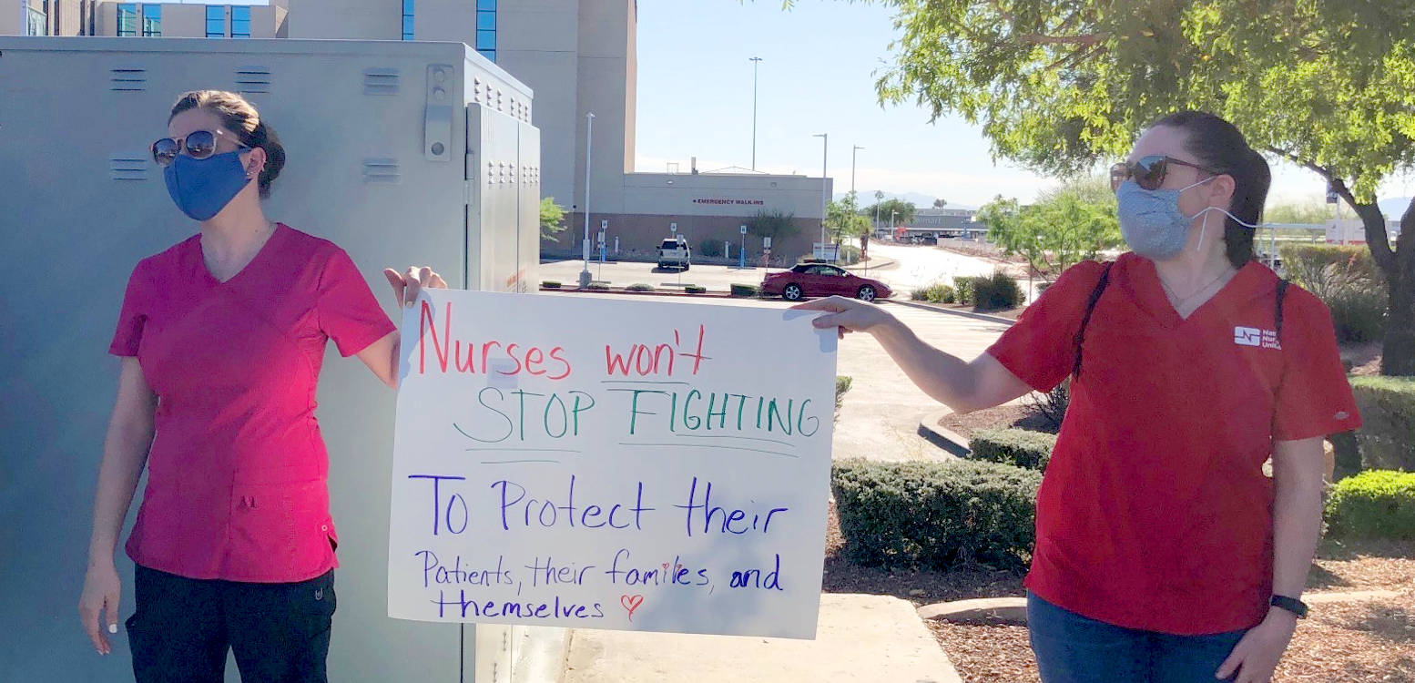 nurses holding signs