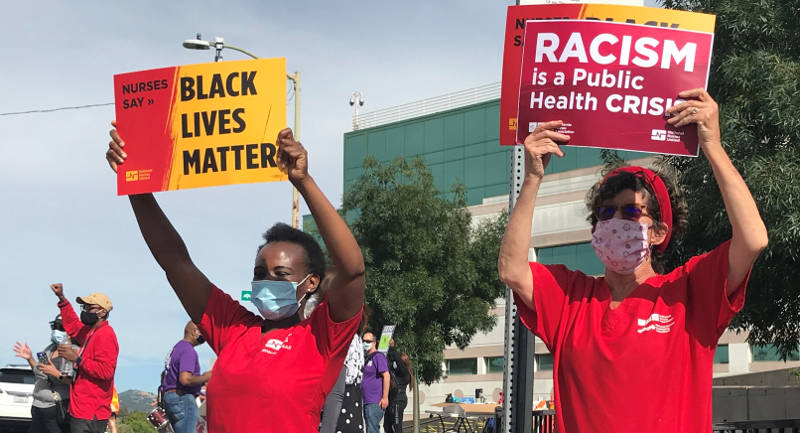 nurses holding signs