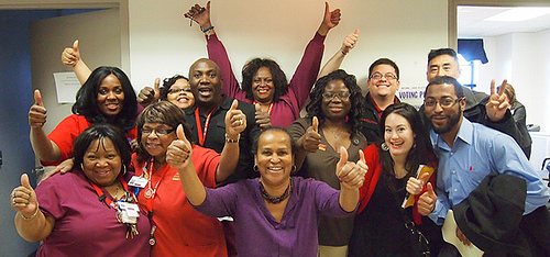 Large group of nurses with raised fists