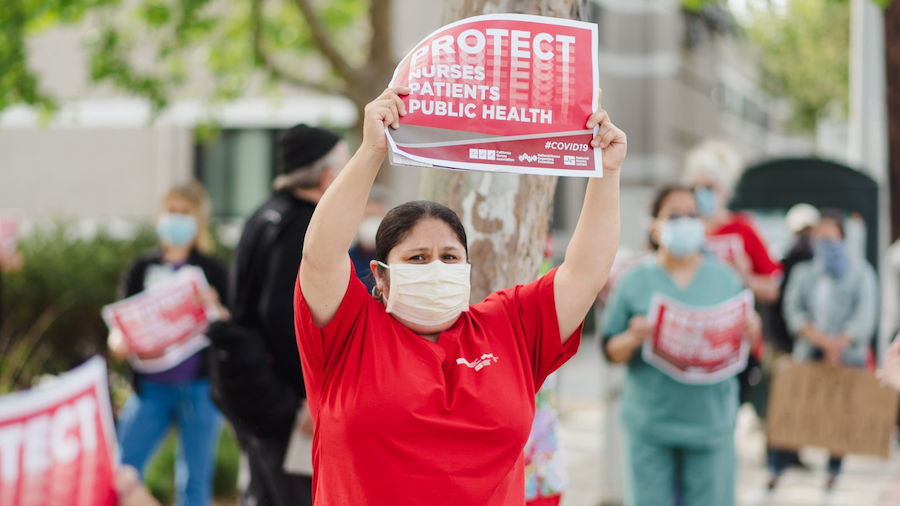 Nurses holds sign "Protect Nurses"