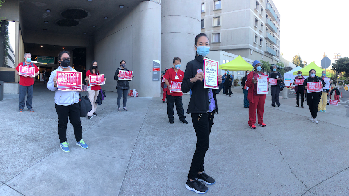 Nurse holds "Protect Nurses" signs