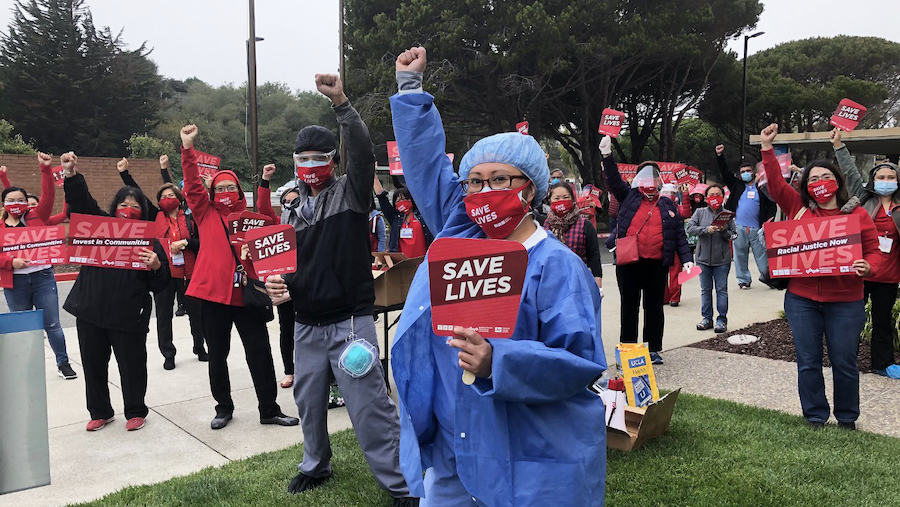 Nurses hold signs "Save Lives"