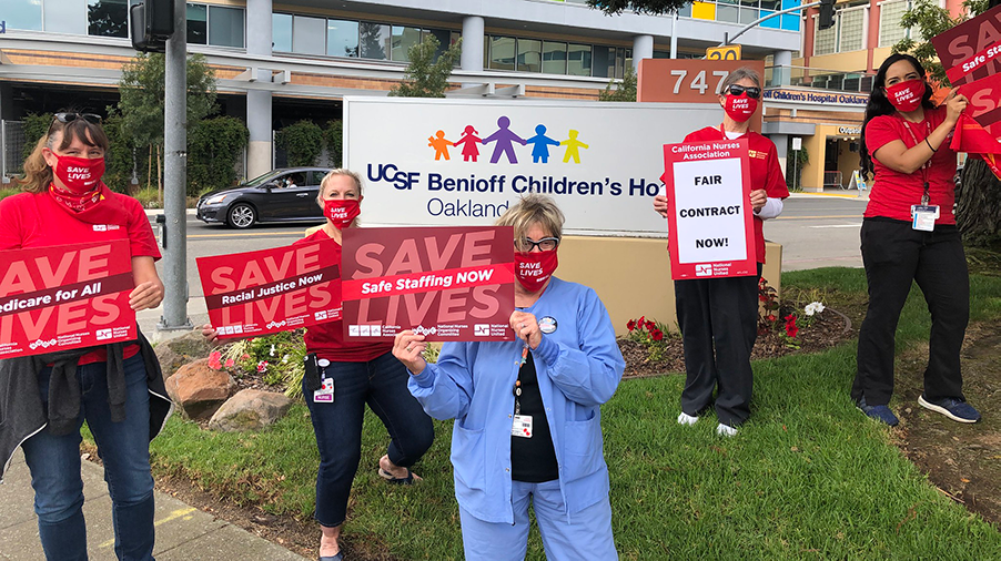 Nurses holds signs for safe staffing