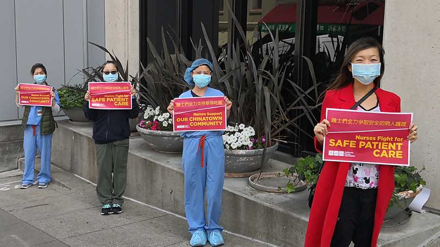 Nurses hold signs calling for patient safety outside Chinese Hospital