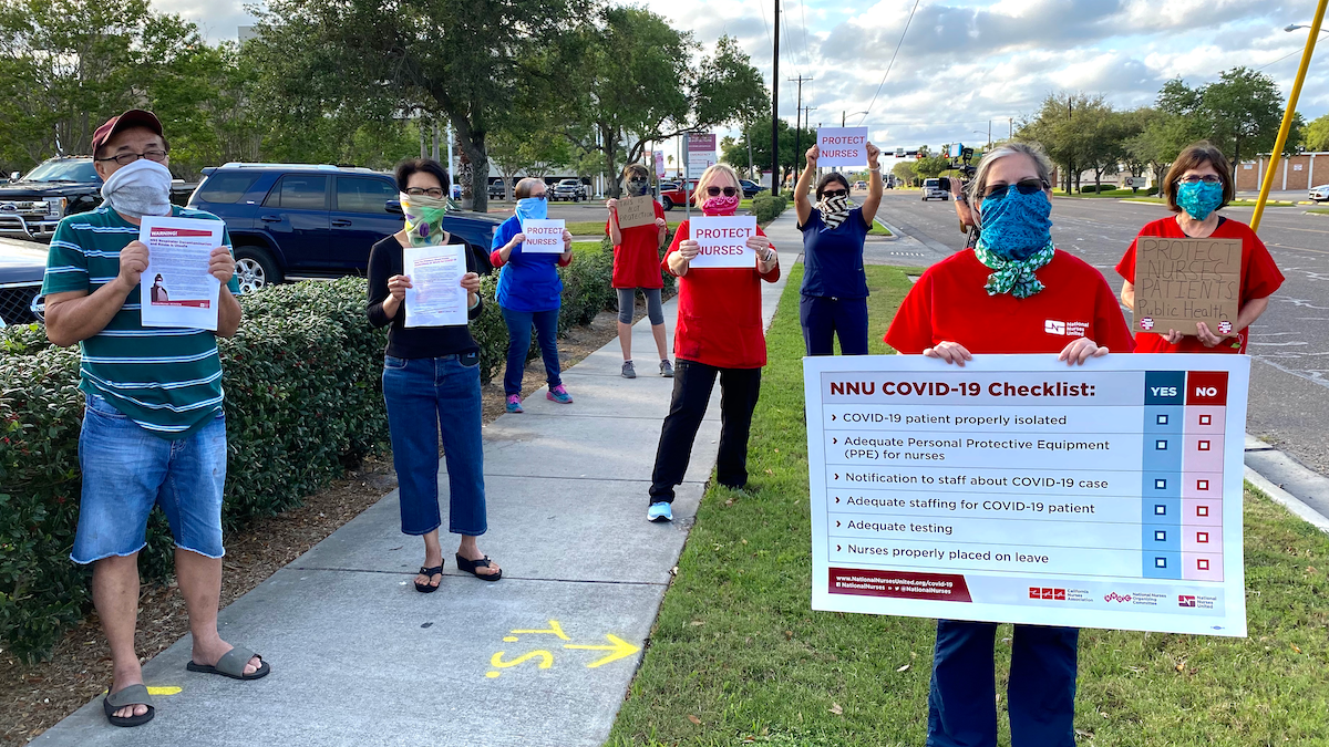 Nurse holds "Protect Nurses" signs
