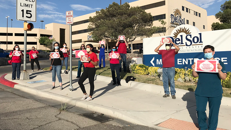 Nures hold signs calling for safety measures outside Del Sol Medical Center