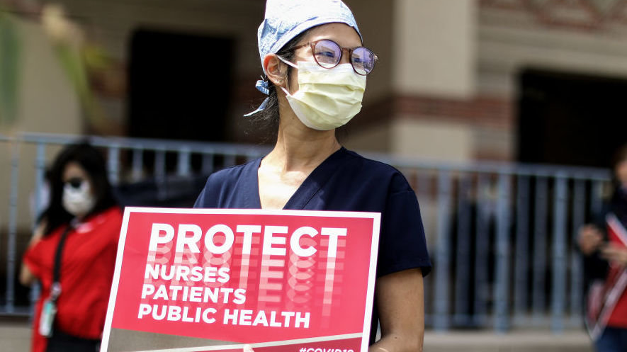 Nurses holding sign "Protect Nurses"