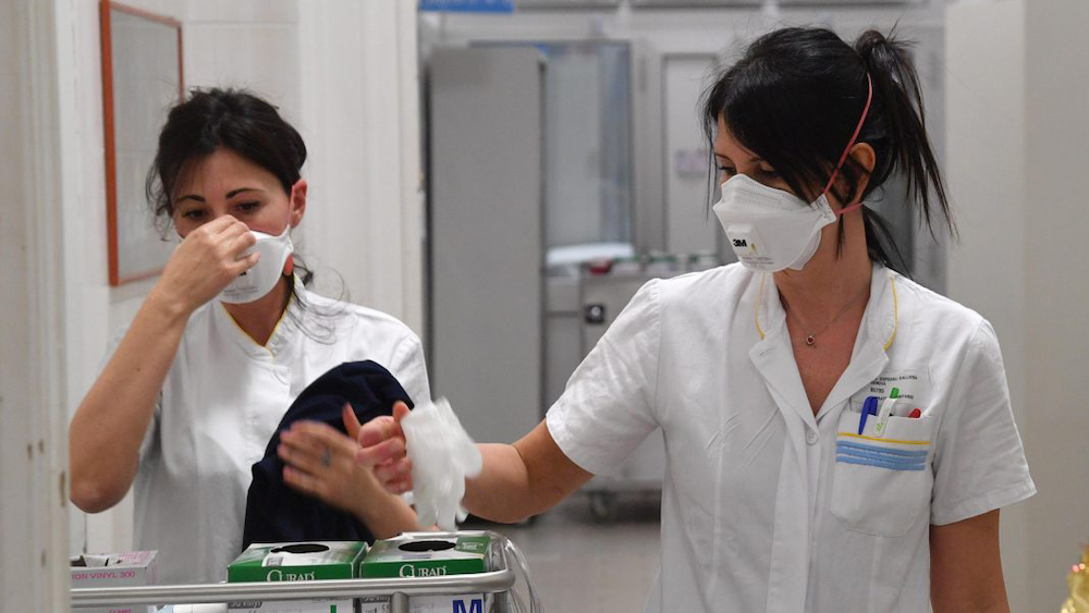 Nurses in masks putting on gloves