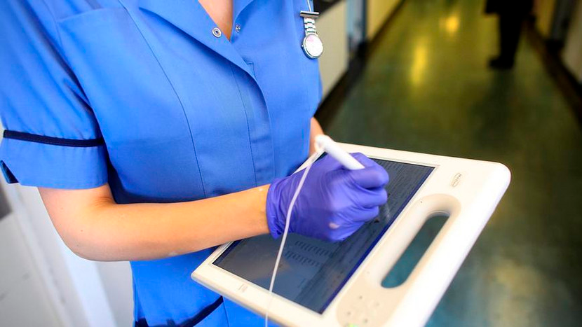 A nurse using a wireless electronic tablet 