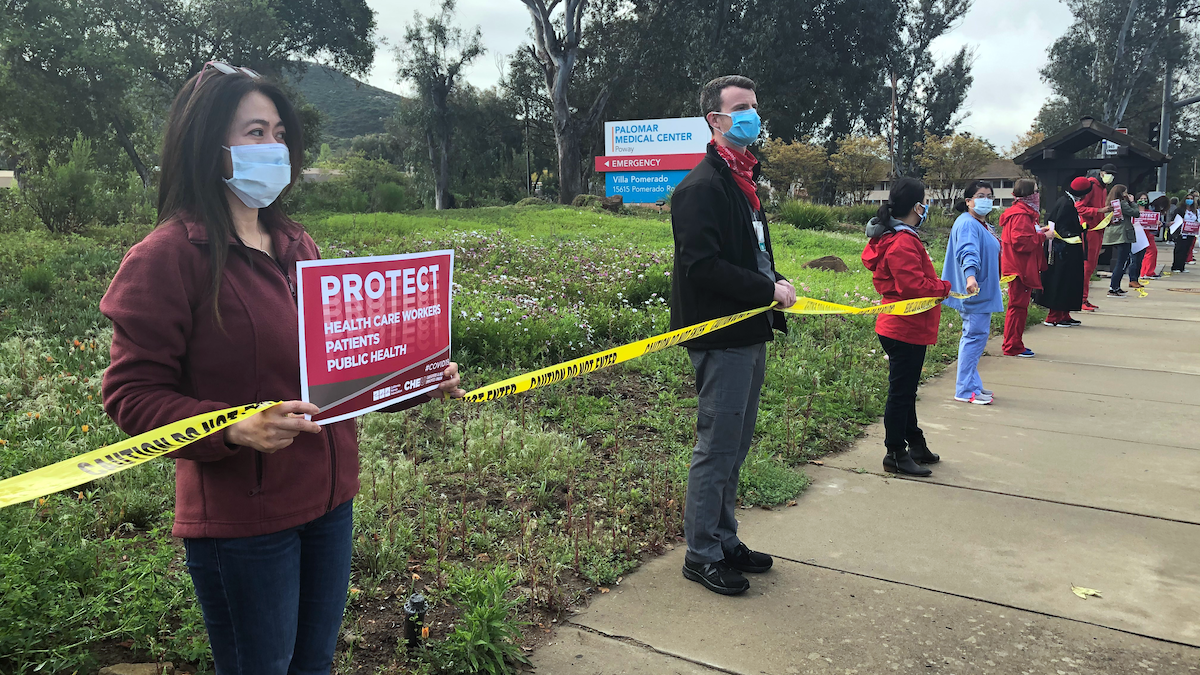Nurses holding signs outside Palomar Health