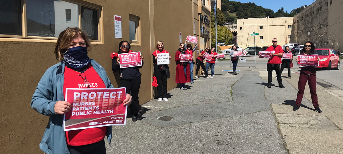 Nurses hold signs "Protect nurses"