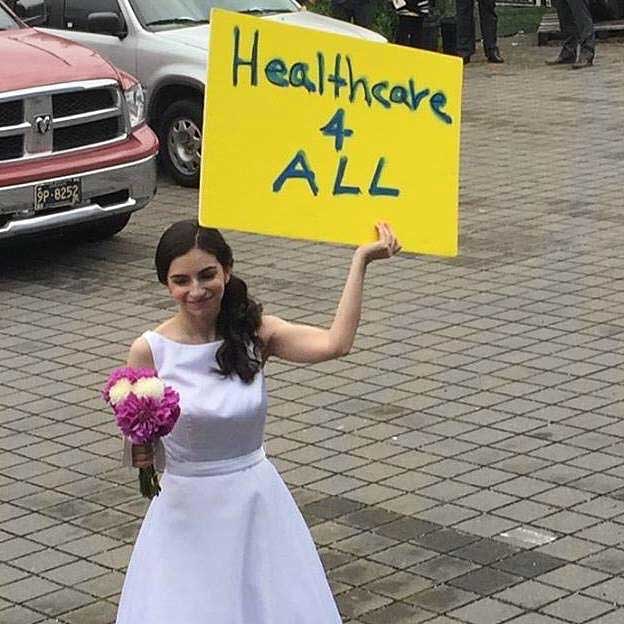 Robyn G. holding sign