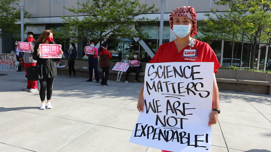 Nurse holds sign "Science matters"