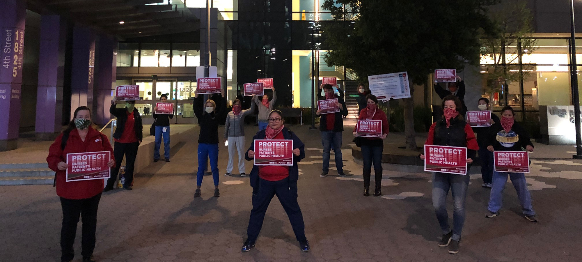 Nurse holds "Protect Nurses" signs