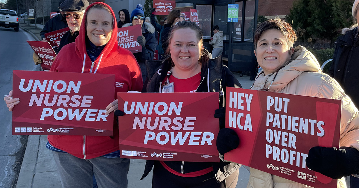 Asheville nurses hold signs that read "Union nurse power."