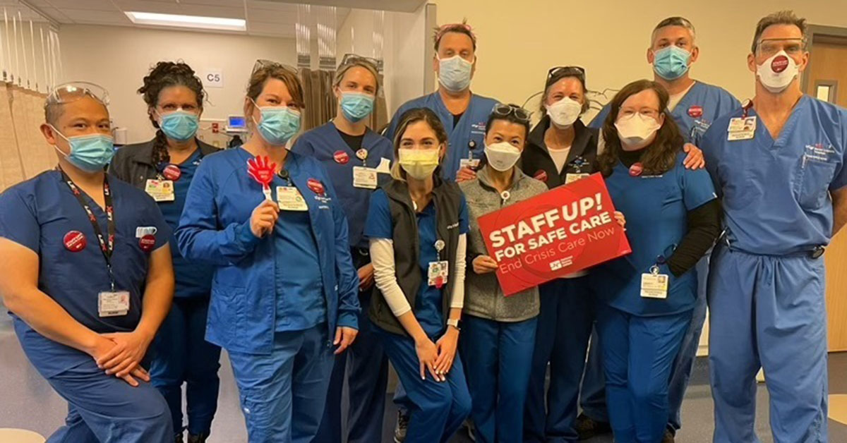 UCSF nurses hold signs in support of safe staffing.