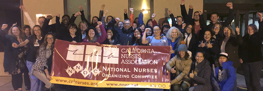 Barton Nurses in front of banner