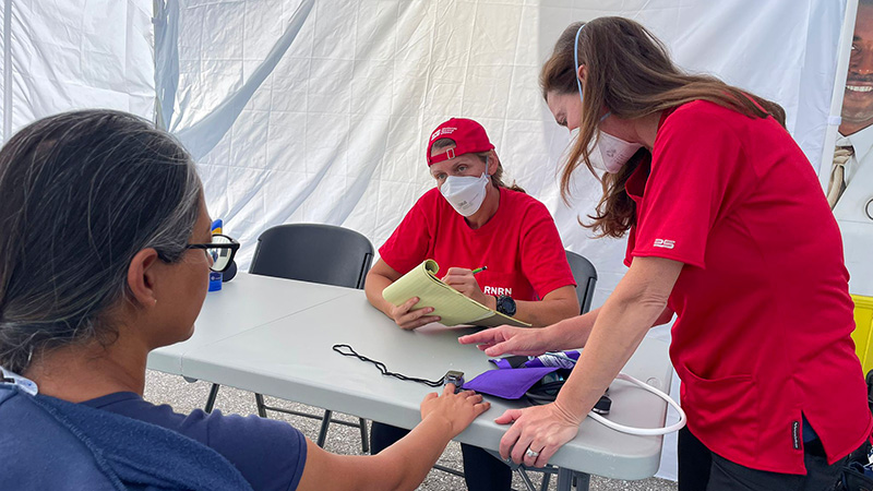 Venessa Soldo-Jones, RN (seated) and Tammi Bachecki, RN with a patient at the mobile medical unit in Florida.