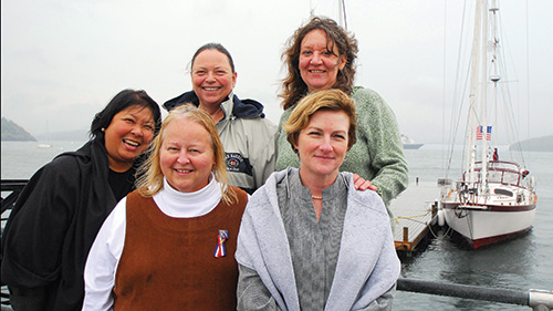 Group of five nurses by harbor