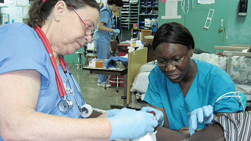Two nurses tending to patient