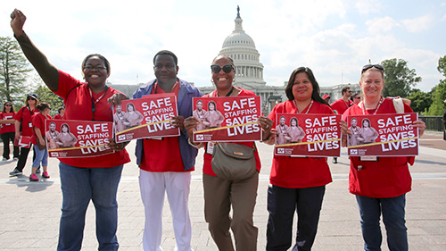 Five nurses outside U.S. Capitol buidling holding signs "Safe Staffing Saves Lives"
