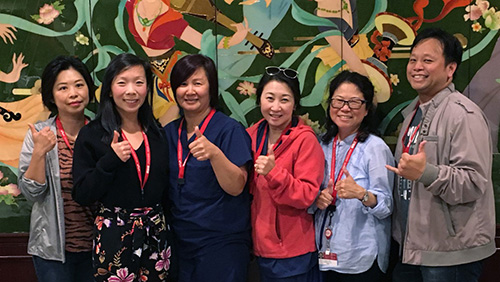 Group of six nurses giving thumbs up.